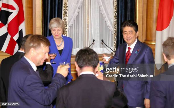 British Prime Minister Theresa May and Japanese Prime Minister Shinzo Abe toast during a dinner at Akasaka State Guesthouse on August 31, 2017 in...