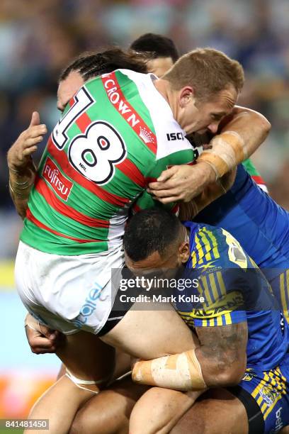 Jason Clark of the Rabbitohs is tackled during the round 26 NRL match between the Parramatta Eels and the South Sydney Rabbitohs at ANZ Stadium on...