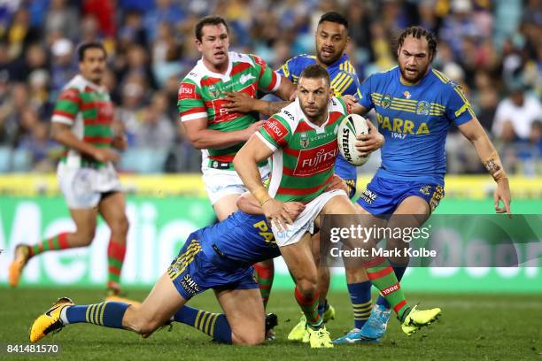 Robbie Farrah of the Rabbitohs is tackled during the round 26 NRL match between the Parramatta Eels and the South Sydney Rabbitohs at ANZ Stadium on...