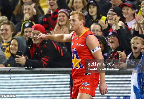 Adam Cooney of the All Stars celebrates after catching a chip in his mouth thrown by a member of the crowd during the 2017 EJ Whitten Legends Game...