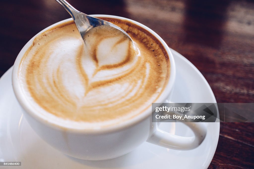 Close up of hot latte coffee on the wooden table.
