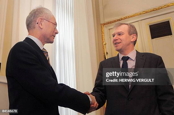 Belgium's new Prime Minister Herman Van Rompuy and his predecessor, former Prime Minister Yves Leterme are pictured during the transfer of office at...