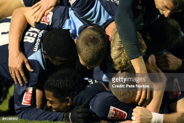 Southend United players celebrate after Junior Stanislas scores the winning goal in the 94th minute during the Coca Cola League One Match between...