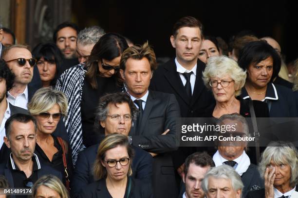 French journalist Laurent Delahousse and guests leave the Saint-Sulpice church to attend the funeral of late actress Mireille Darc on September 1,...