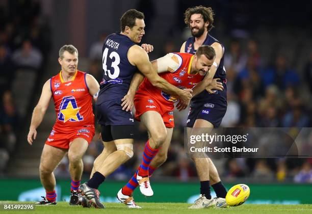 Anthony Koutoufides of Victoria and Clark Keating of the All Stars compete for the ball during the 2017 EJ Whitten Legends Game between Victoria and...