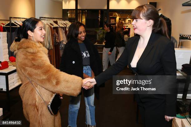 Petta Chua and Bethie Girmai talk to a Scanlan and Theodore employee during Vogue American Express Fashion's Night Out 2017 on September 1, 2017 in...