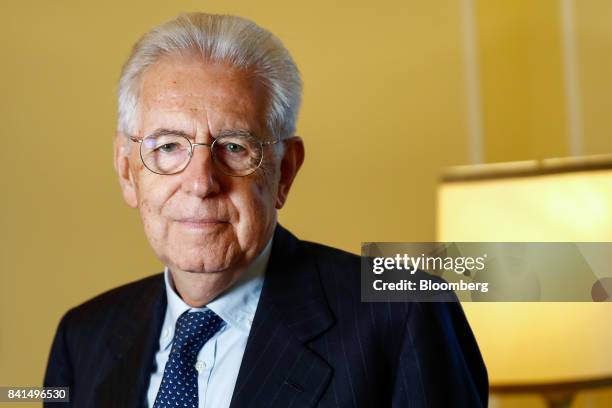 Mario Monti, Italy's former prime minister, poses for a photograph before a Bloomberg Television interview at the Ambrosetti Forum in Cernobbio,...