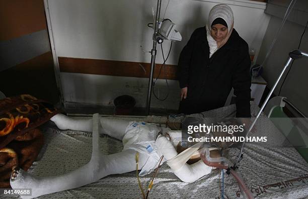 Palestinian boy Hosam Hamdan lies on December 31, 2008 in Gaza City�s al-Shifa hospital intensive care unity after he was wounded and his two sisters...