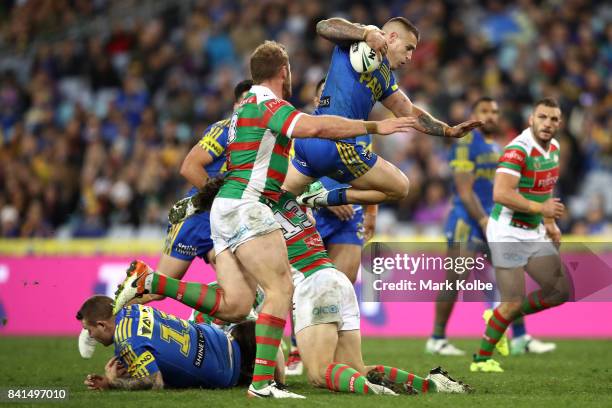 Cameron King of the Eels is tackled during the round 26 NRL match between the Parramatta Eels and the South Sydney Rabbitohs at ANZ Stadium on...