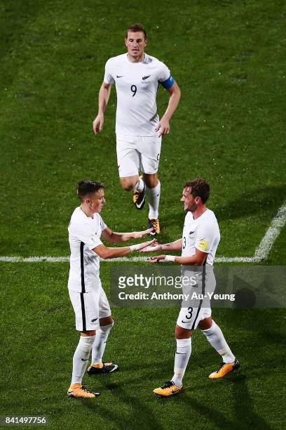 Ryan Thomas of New Zealand is congratulated by teammates Deklan Wynne and Chris Wood after scoring a goal during the 2018 FIFA World Cup Qualifier...