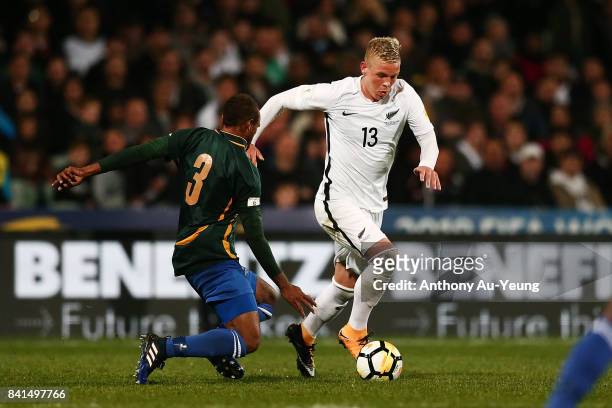 Monty Patterson of New Zealand on the attack against Robert Laua of Solomon Islands during the 2018 FIFA World Cup Qualifier match between the New...