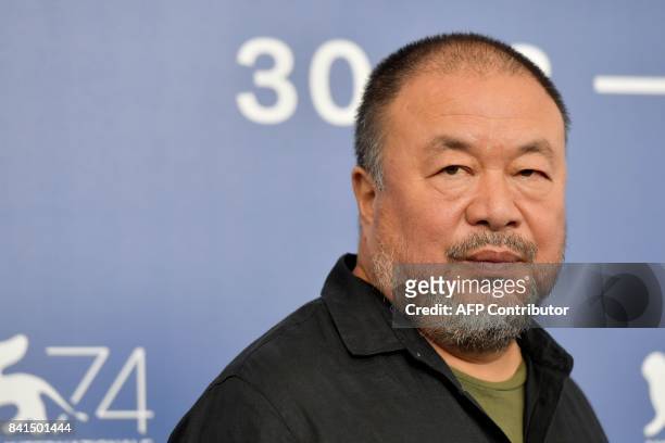 Chinese artist and producer Ai Weiwei attends the photocall of the movie "Human Flow" presented in competition at the 74th Venice Film Festival on...