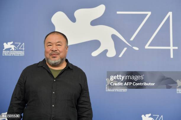 Chinese artist and producer Ai Weiwei attends the photocall of the movie "Human Flow" presented in competition at the 74th Venice Film Festival on...