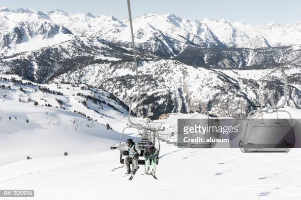 man and woman on ski lift in baqueira beret catalonia spain - baqueira/beret imagens e fotografias de stock
