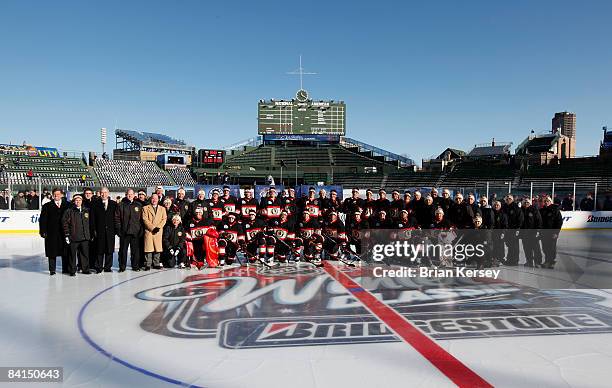 The Chicago Blackhawks pose on the ice during practice a day before playing against the Detroit Red Wings in the NHL Winter Classic at Wrigley Field...