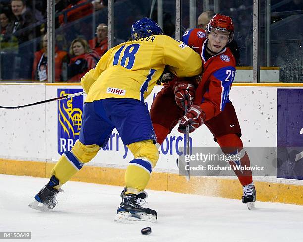 Joakim Andersson of Team Sweden body checks Alexei Potapov of Team Russia during the IIHF World Junior Championships at the Ottawa Civic Centre on...