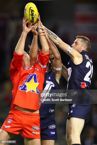 Troy Luff of the All Stars, Heath Scotland of Victoria and Matt Spangher of Victoria compete for the ball during the 2017 EJ Whitten Legends Game...