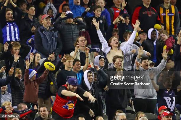 Fans in the crowd celebrate after a goal during the 2017 EJ Whitten Legends Game between Victoria and the All Stars at Etihad Stadium on September 1,...