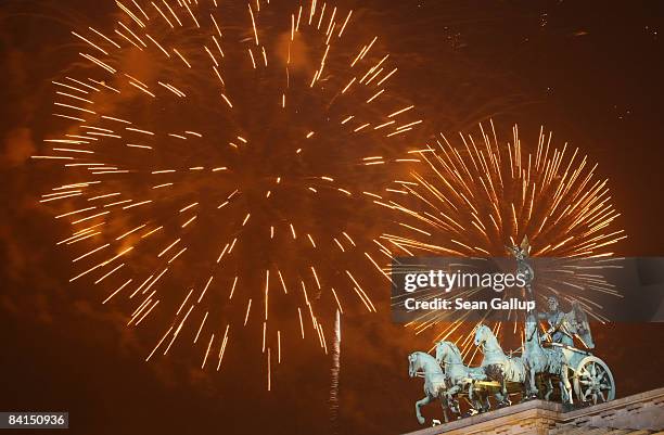 Fireworks explode over the Quadriga sculpture on the Brandenburg Gate in celebration of the new year on January 1, 2009 in Berlin, Germany. An...