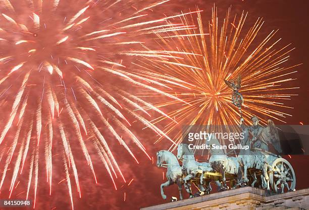 Fireworks explode over the Quadriga sculpture on the Brandenburg Gate in celebration of the new year on January 1, 2009 in Berlin, Germany. An...