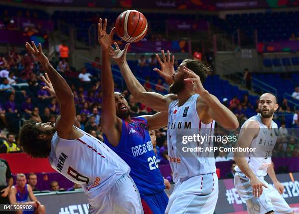 Great Britain's Kieron Achara vies for the ball with Belgium's Jean-Marc Mwena and Sam Van Rossom during the FIBA Eurobasket 2017 men's group D...