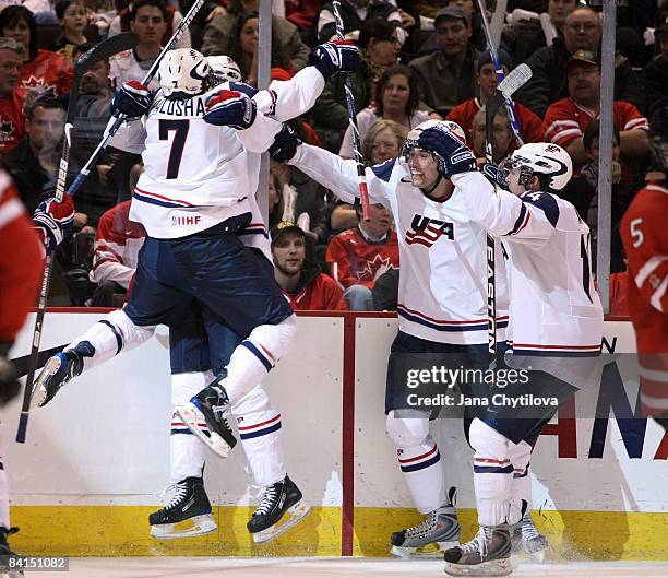 Aaron Palushaj of Team USA celebrates his team's goal with teammates Jimmy Hayes, Eric Tangradi and Mitch Wahl in a game against Team Canada during...