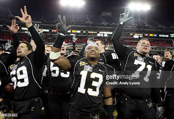 David Giller, Chris Marve and Joey Bailey of the Vanderbilt Commodores celebrate with the team after winning the Gaylord Hotels Music City Bowl...