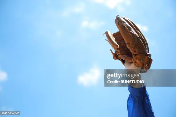 close up of male hand wearing baseball glove - baseball glove stock pictures, royalty-free photos & images