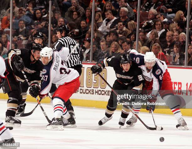 Manny Malhotra and Rick Nash of the Columbus Blue Jackets battle for position against Samuel Pahlsson and Travis Moen of the Anaheim Ducks during the...