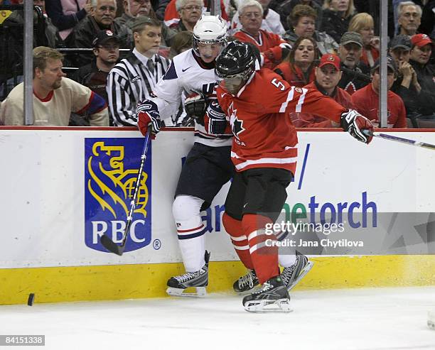 Subban of Team Canada checks Drayson Bowman of Team USA into the boards during the IIHF World Junior Championships held at Scotiabank Place on...