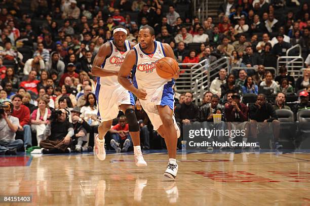 Fred Davis of the Los Angeles Clippers brings the ball up the court while teammate Al Thornton follows behind during their game against the...