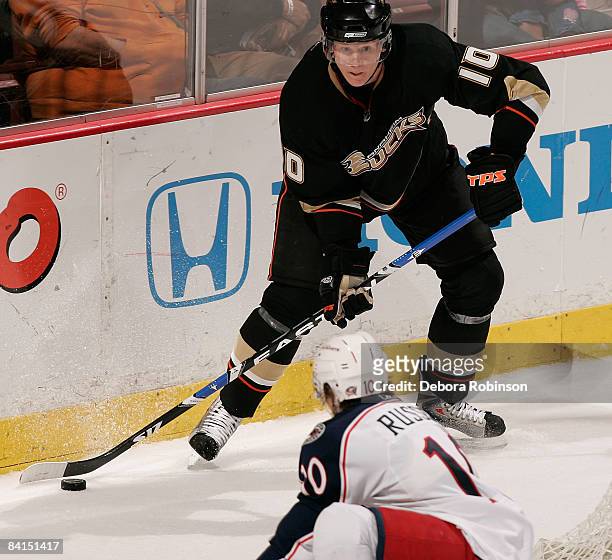 Kris Russell of the Columbus Blue Jackets defends behind the net against Corey Perry of the Anaheim Ducks during the game on December 31, 2008 at...