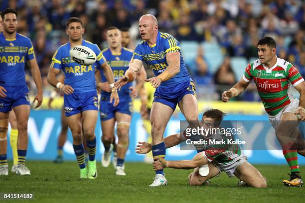 Beau Scott of the Eels passes as he is tackled during the round 26 NRL match between the Parramatta Eels and the South Sydney Rabbitohs at ANZ...