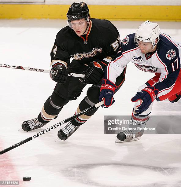 Andrew Murray of the Columbus Blue Jackets reaches in for the puck against Bobby Ryan of the Anaheim Ducks during the game on December 31, 2008 at...