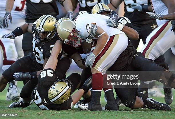 Josh Haden of the Boston College Eagles is stopped by the Vanderbilt Commodores defense during the Gaylord Hotels Music City Bowl at LP Field on...