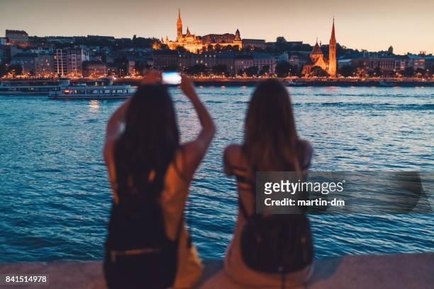 Young women in Budapest taking photos