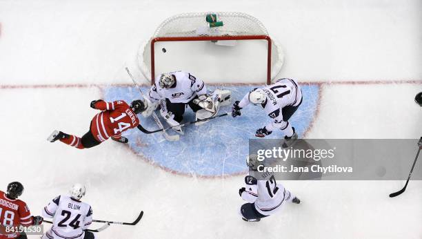 Jordan Eberle of Team Canada scores against Thomas McCollum of Team USA as team mates Jimmy Hayes and Ryan McDonagh of Team USA look on during the...
