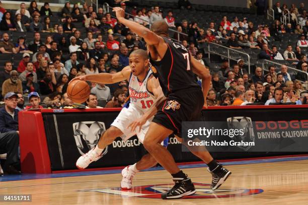 Eric Gordon of the Los Angeles Clippers dribbles against Andre Miller of the Philadelphia 76ers at Staples Center on December 31, 2008 in Los...