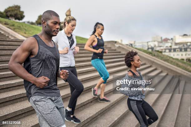four people running steps on a park in san francisco - san francisco marathon stock pictures, royalty-free photos & images