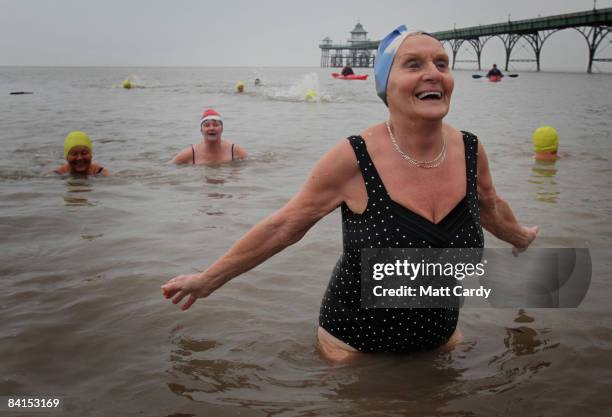 Joyce Peters from the Middle Yeo Surf Lifesaving Club laughs as she takes part in their annual charity New Years Day swim in the Bristol Channel on...
