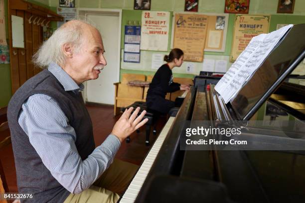 Russian piano teacher Borys Ferodov gives lessons to pianist virtuoso Maria Matsiievska at the Special Music School Lysenko of Kiev as the first of...