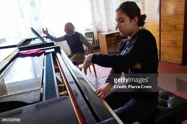 Russian piano teacher Borys Ferodov gives lessons to pianist virtuoso Maria Matsiievska at the Special Music School Lysenko of Kiev as the first of...