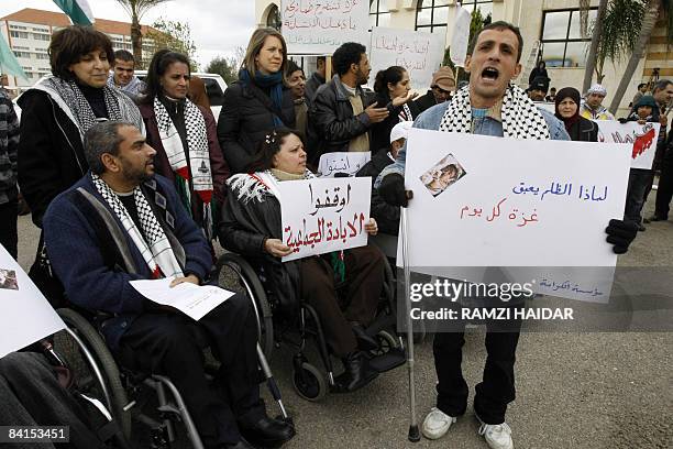 Lebanese and Palestinian handicapped activists hold slogans sympathising with Gaza during a demonstration outside a meeting of the Arab Parliamentary...