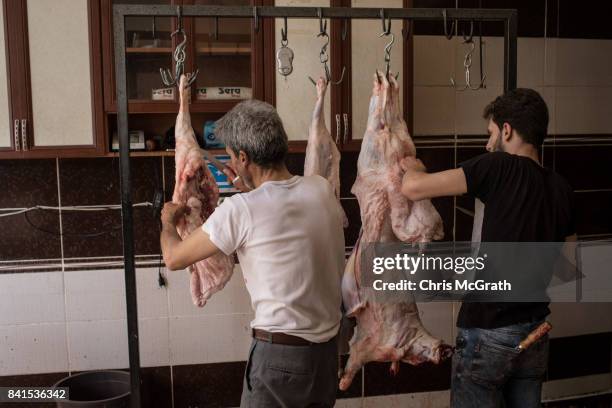 Butchers cut the meat off sacrificial sheep after they were slaughtered during Eid-al-Adha celebrations on September 01, 2017 in Kilis, Turkey,...