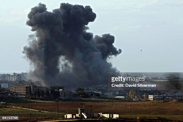 Huge column of smoke and debris rises after Israeli Air Force bombs exploded on Palestinian targets in the northern Gaza Strip January 1, 2009 as...