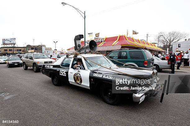 Fans of the Chicago Blackhawks dress up as members of the "Blues Brothers" and drive a car modeled after the "Blues Mobile" prior to the Winter...