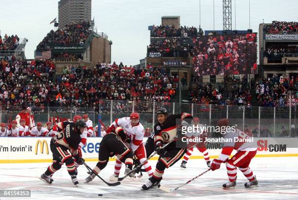 The Chicago Blackhawks play in the first period against the Detroit Red Wings during the NHL Winter Classic at Wrigley Field on January 1, 2009 in...
