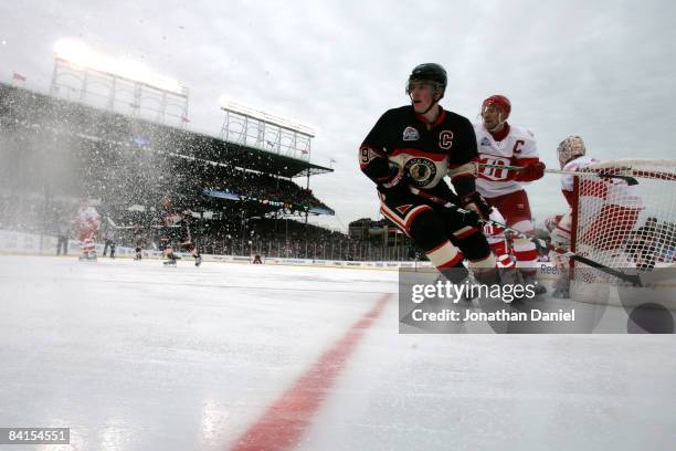 Jonathan Toews of the Chicago Blackhawks skates against Nicklas Lidstrom of the Detroit Red Wings during the NHL Winter Classic at Wrigley Field on...