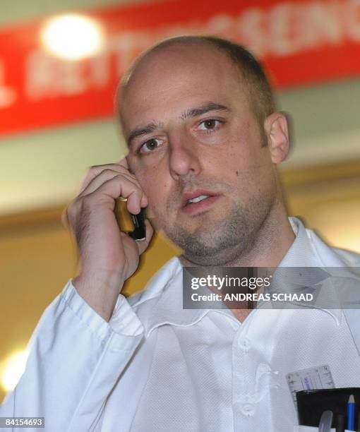 Dr. Christoph Kollersbeck, a member of the hospital of Schwarzach, Austria speaks on a phone on January 1, 2009 after the Premier of the central...