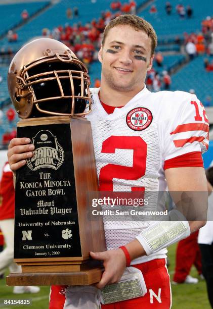 Quarterback Joe Ganz of the Nebraska Cornhuskers holds the MVP trophy following the Konica Minolta Gator Bowl against the Clemson Tigers at...